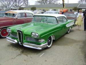 This car is a custom. It is identified as such because it is based on a 1950's car and has clean paint, is lowered and has a clean interior but does not have billet rims. 