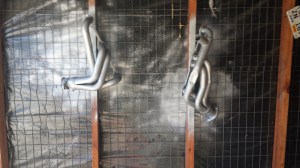 Headers hanging on the wall being painted. 3 coats seemed to be about right. I also had 2 coats of VHT primer. 