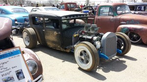 This is a Model A Ford Sedan with header wrap. It's barely visible behind the front tire, but it was the best picture I had, and again, sweet car. Picture is justified in my blog!