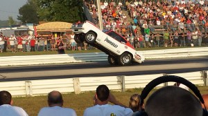 Awesome Barracuda pulling a wheelie at the drag strip.
