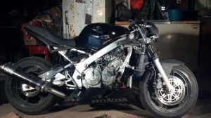 My friend, Frankie's, Street fighter. Built out of a wrecked Honda F3 600. Originally a super sport crotch rocket. It's a naked bike/street fighter because the faring are all removed, Covering the front of the bike, the sides of the engine, and the rear under tail faring. A new front headlight was added.